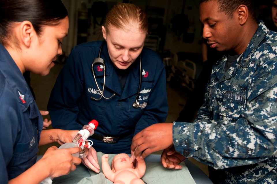 US Navy 120207-N-CS815-319 Hospital Corpsman 2nd Class Adriana Fotu, left, Hospital Corpsman 1st Class Sara Ramos and Hospital Corpsman 3rd Class B photo