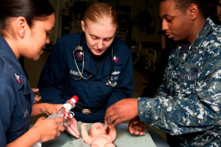 US Navy 120207-N-CS815-319 Hospital Corpsman 2nd Class Adriana Fotu, left, Hospital Corpsman 1st Class Sara Ramos and Hospital Corpsman 3rd Class B