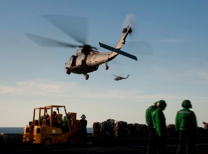 US Navy 120209-N-DR144-361 MH-60S Sea Hawk helicopters assigned to Helicopter Anti-Submarine Squadron (HSC) 23 deliver supplies to the flight deck