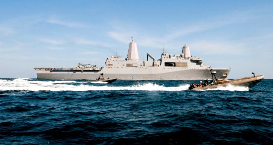 US Navy 120207-N-PB383-227 Sailors drive rigid hull inflatable boats past the amphibious transport dock ship USS New Orleans (LPD 18) during small