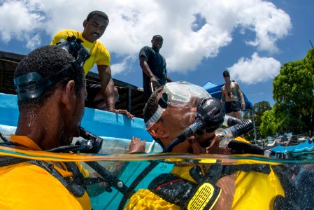 US Navy divers and Belizean coast guard divers practice SCUBA emergency procedures in a pool 140625-N-IP743-096