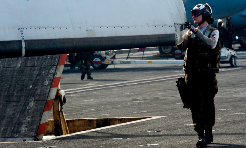 US Navy 120207-N-OY799-032 Aviation Structural Mechanic 3rd Class Tia Squirres performs pre-flight checks on the wing of an E-2C Hawkeye
