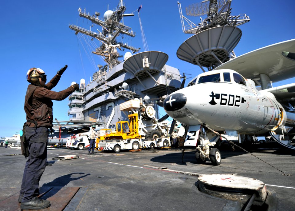 US Navy 120206-N-YB753-046 Aviation Structural Mechanic Airman Gregory Hardway relays pre-flight signals between pilots and maintainers on the flig
