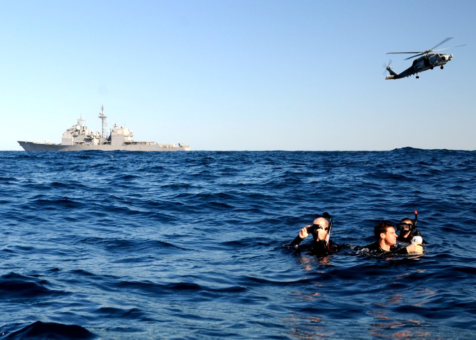 US Navy 120207-N-BC134-664 Sailors assigned to the guided-missile cruiser USS Bunker Hill wait for an SH-60B Sea Hawk helicopter during search and