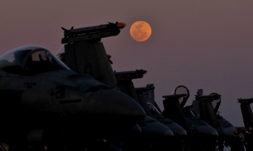 US Navy 120208-N-ZI635-549 The moon rises over aircraft on the flight deck aboard the Nimitz-class aircraft carrier USS Carl Vinson (CVN 70)