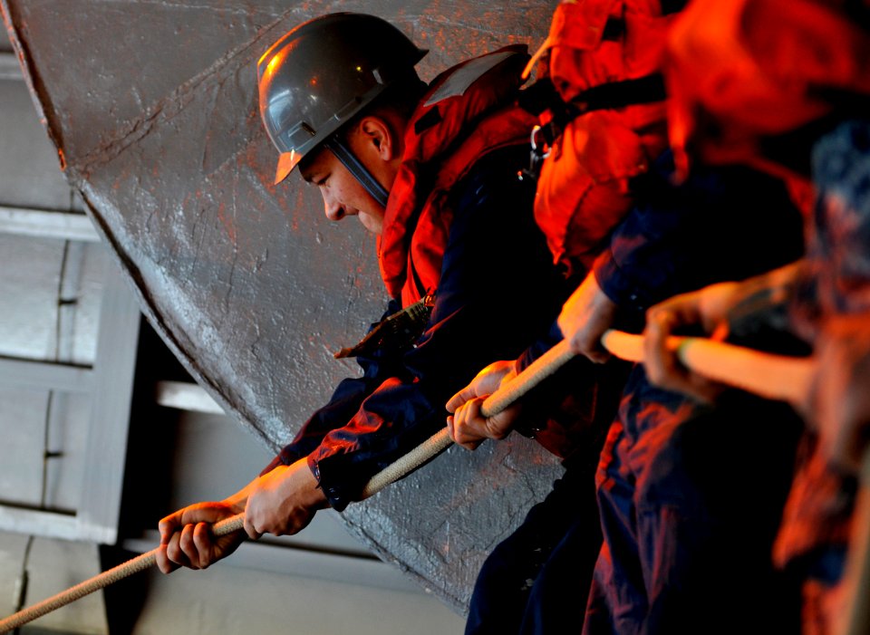 US Navy 120207-N-ZI635-305 Sailors ready a rigid-hull inflatable boat during a man overboard drill