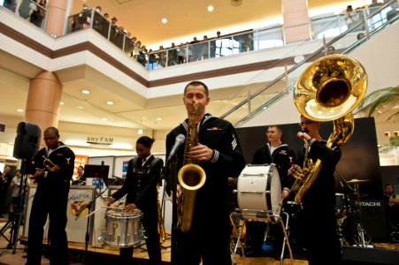 US Navy 120207-N-CZ945-043 Musician Seaman Brandon Kies, assigned to the U.S. 7th Fleet Brass Band, plays the saxophone during a performance at the