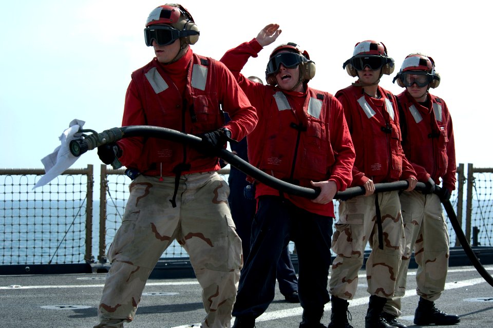 US Navy 120208-N-KS651-126 Sailors participate in a flight deck fire fighting drill aboard the amphibious dock landing ship USS Pearl Harbor (LSD 5