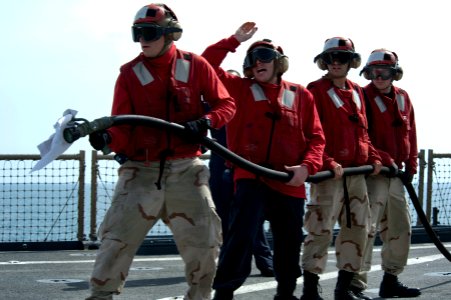 US Navy 120208-N-KS651-126 Sailors participate in a flight deck fire fighting drill aboard the amphibious dock landing ship USS Pearl Harbor (LSD 5
