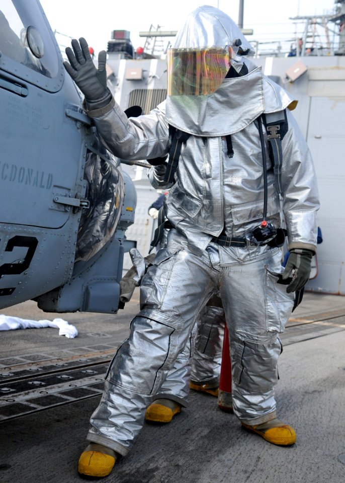 US Navy 120207-N-ZF681-306 Hull Maintenance Technician 3rd Class Christopher Mitchell checks an SH-60B Sea Hawk helicopter for hot spots during a f