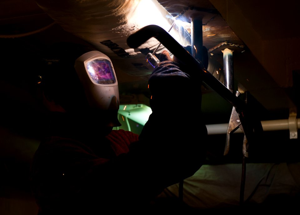 US Navy 120207-N-FI736-215 Hull Technician 3rd Class Nicholas Smith welds a pull-up bar in place aboard the aircraft carrier USS Enterprise (CVN 65