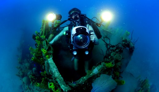 US Navy 120210-N-XD935-180 Mass Communication Specialist 1st Class Shane Tuck films coral growth in the pilot house of a sunken naval landing craft