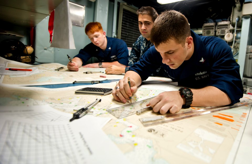 US Navy 120208-N-GC412-019 Operations Specialist 3rd Class Aleksandar Miladinovic, one of the ship's chart petty officers, plots the ship's inboard