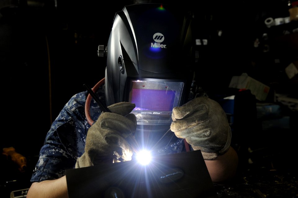 US Navy 120209-N-RG587-154 Hull Maintenance Technician Fireman Adam Garcia uses a tig welder to join two pieces of steel in the metalsmithing shop