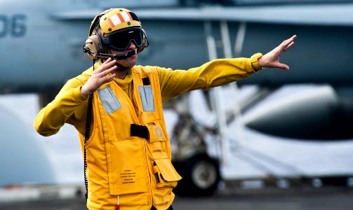 US Navy 120208-N-OY799-470 Aviation Boatswain's Mate (Handling) 3rd Class Michael Condlin irects a fixed wing aircraft on the flight deck of the Ni