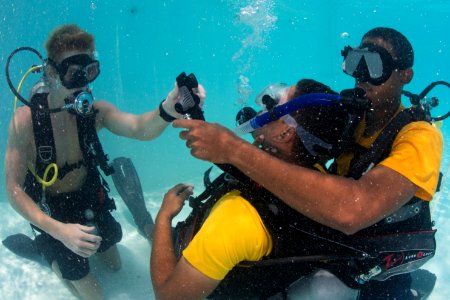 US Navy divers and Belizean coast guard divers practice SCUBA emergency procedures in a pool 140625-N-IP743-089