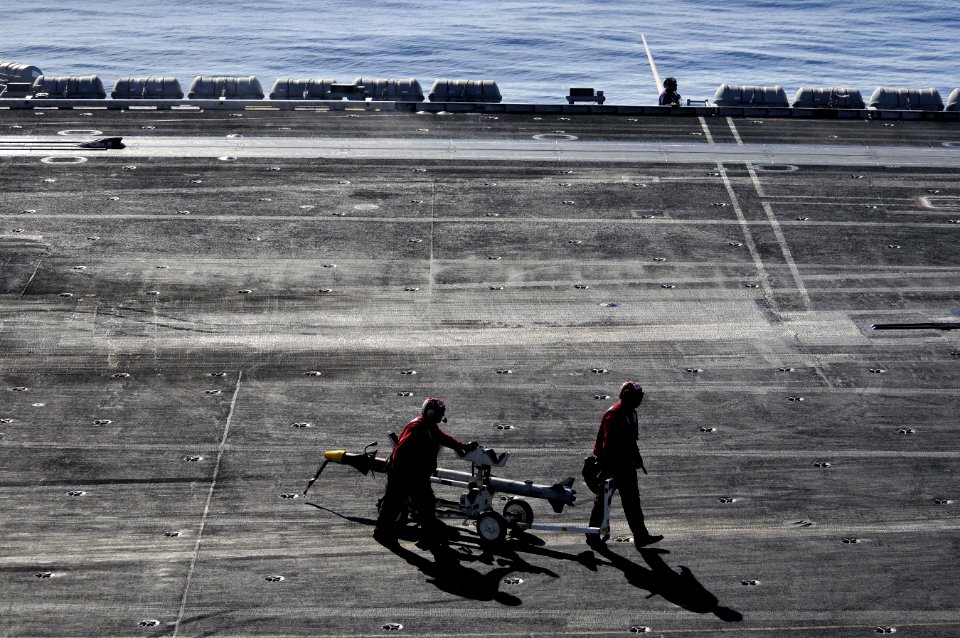 US Navy 120208-N-UT411-866 Aviation Ordnancemen move ordinance on the flight deck aboard the Nimitz-class aircraft carrier USS Carl Vinson (CVN 70)