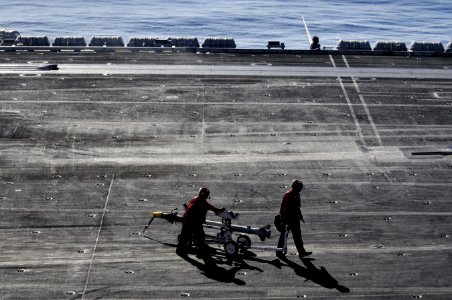US Navy 120208-N-UT411-866 Aviation Ordnancemen move ordinance on the flight deck aboard the Nimitz-class aircraft carrier USS Carl Vinson (CVN 70)