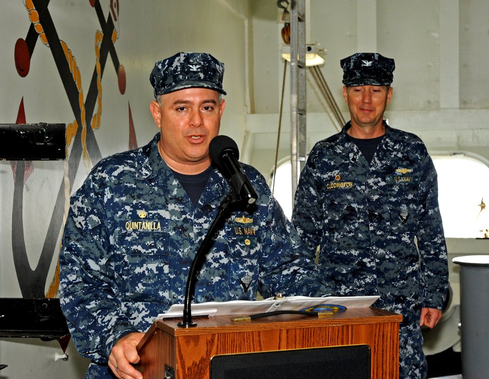 US Navy 120212-N-DX615-043 Capt. Humberto L. Quintanilla II reads his orders, as Capt. Donald R. Cuddington stands by to assume command of Amphibio