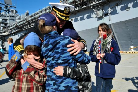 US Navy 120207-N-QY430-112 Capt. Erik Ross, commanding officer of the amphibious assault ship USS Bataan (LHD 5), greets his family during a homeco