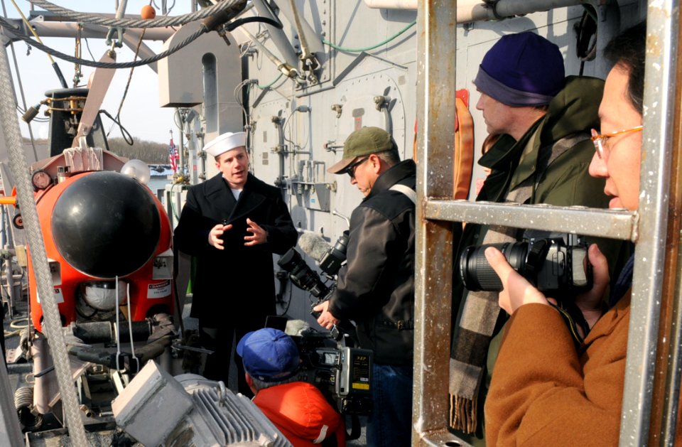 US Navy 120210-N-MU720-015 Mineman Seaman Bryan Surber, assigned to the mine countermeasures ship USS Patriot (MCM 7), talks to local media about t