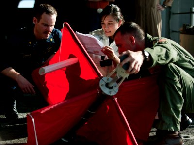 US Navy 120209-N-DR144-754 Sailors assemble a drifting buoy used to measure ocean currents before deploying it from the fantail of the Nimitz-class