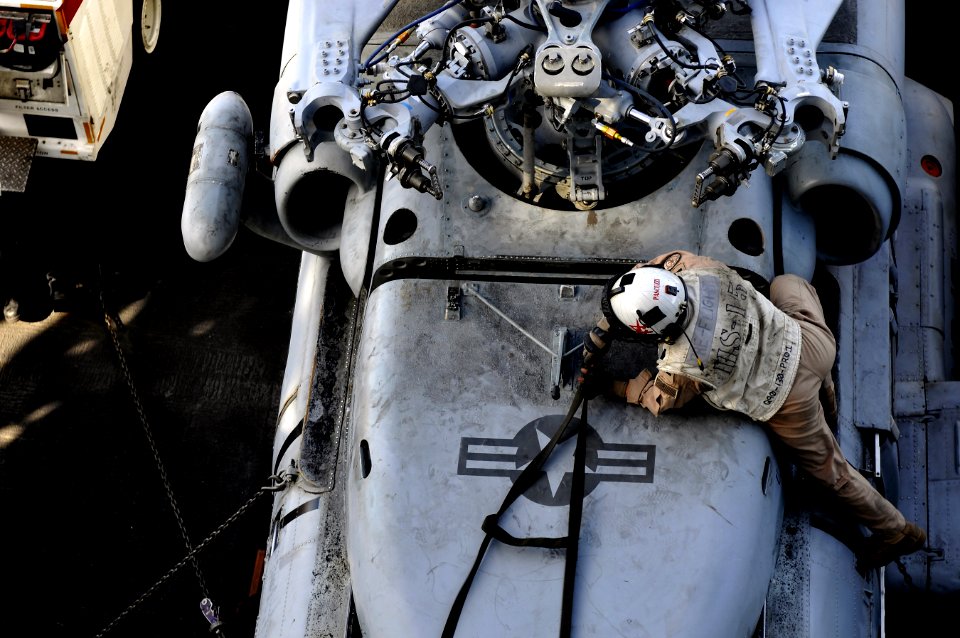 US Navy 120208-N-UT411-686 Lt. j.g. Julian Pascuzzi inspects an HH-60H Sea Hawk helicopter before flight operations aboard the Nimitz-class aircraf