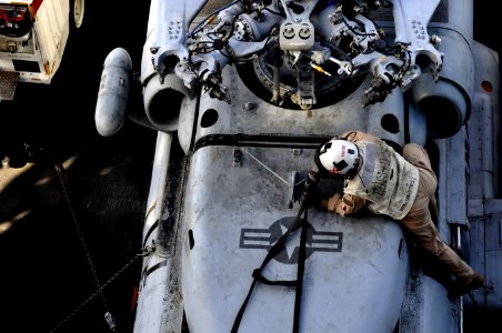 US Navy 120208-N-UT411-686 Lt. j.g. Julian Pascuzzi inspects an HH-60H Sea Hawk helicopter before flight operations aboard the Nimitz-class aircraf