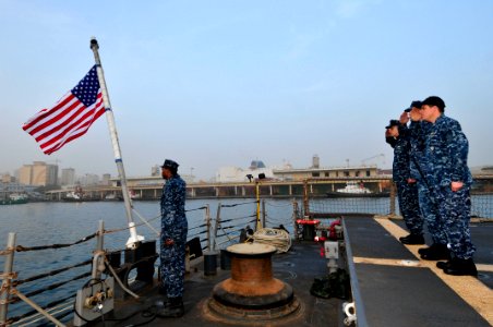 US Navy 120208-N-IZ292-017 Sailors aboard the guided-missile frigate USS Simpson (FFG 56) observe morning colors photo