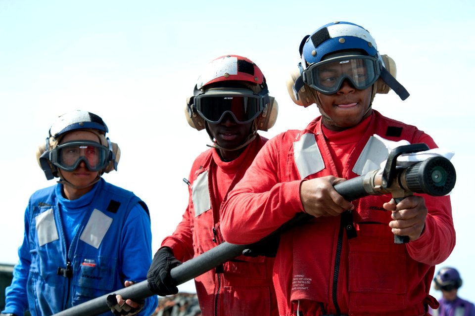US Navy 120208-N-KS651-131 Sailors participate in a flight deck fire fighting drill aboard the amphibious dock landing ship USS Pearl Harbor (LSD 5