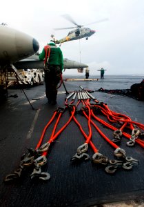 US Navy 120208-N-OY799-002 A Sailor organizes cargo hooks on the flight deck of the Nimitz-class aircraft carrier USS John C. Stennis (CVN 74) duri