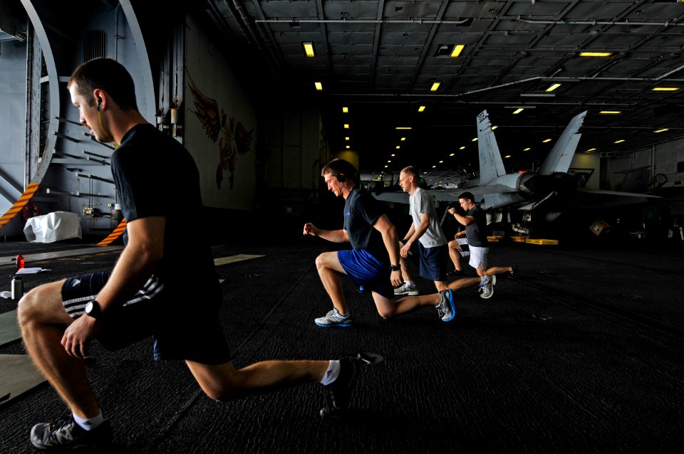 US Navy 120210-N-ZI635-041 Sailors participate in a Tactical UnderWay Fitness (TUF) class in the hangar bay aboard the Nimitz-class aircraft carrie