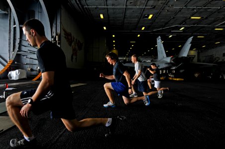 US Navy 120210-N-ZI635-041 Sailors participate in a Tactical UnderWay Fitness (TUF) class in the hangar bay aboard the Nimitz-class aircraft carrie