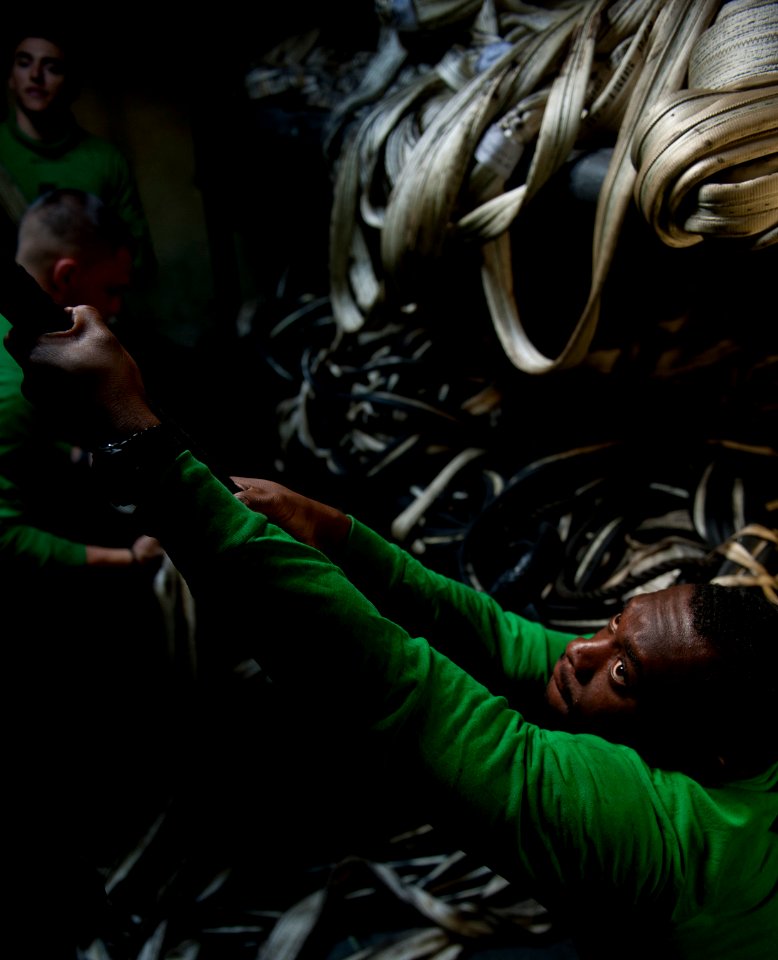 US Navy 120210-N-DR144-682 Sailors stow barricades below decks after flight deck drills aboard the Nimitz-class aircraft carrier USS Carl Vinson (C