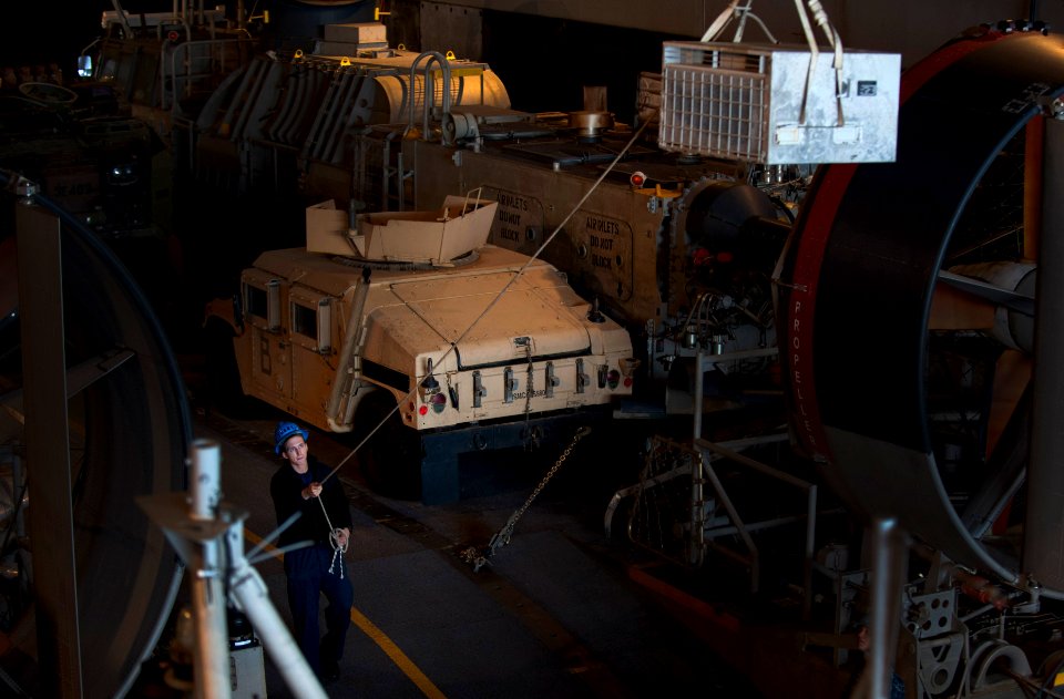 US Navy 120208-N-PB383-424 A Sailor guides equipment onto a landing craft, air cushion
