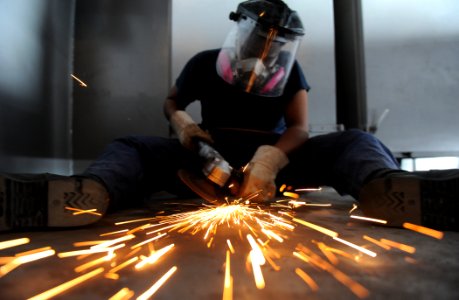 US Navy 120208-N-XE109-030 Seaman Joy Huggins grinds non-skid on the boat deck of the aircraft carrier USS George H.W. Bush (CVN 77) photo