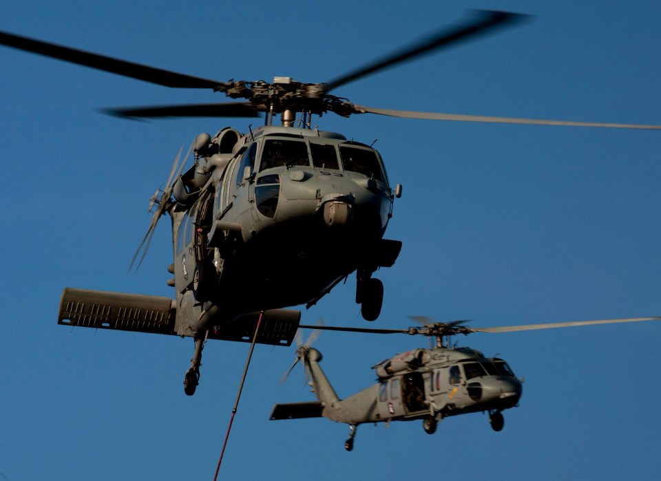 US Navy 120209-N-DR144-273 MH-60S Sea Hawk helicopters assigned to Helicopter Anti-Submarine Squadron (HSC) 23 deliver supplies to the flight deck