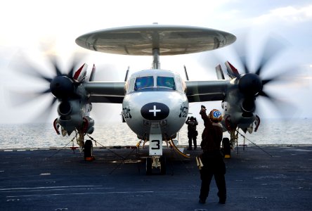 US Navy 120213-N-JN664-083 A plane captain relays hand signals between maintainers and pilots of an E-2C Hawkeye assigned to the Sun Kings of Airbo photo
