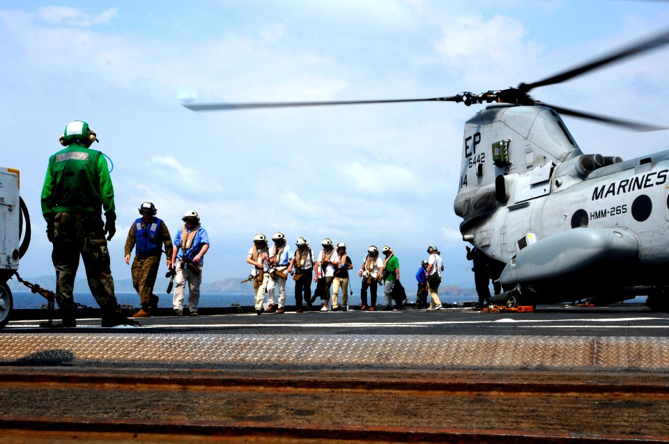 US Navy 120212-N-WV964-152 Mock non-combatant evacuation operation (NEO) participants exit a CH-46 Sea Knight helicopter aboard the forward-deploye