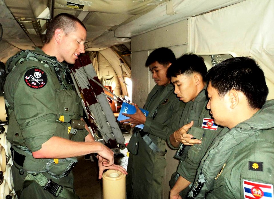US Navy 120211-N-ZZ999-003 Royal Thai navy aviators listen to Naval Aircrewman 2nd Class Scott Kehn as he explains how a sonobuoy is used to track
