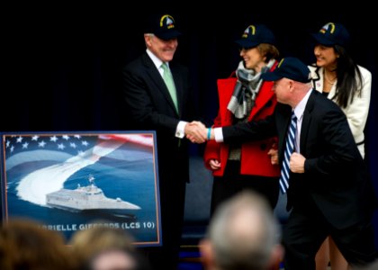US Navy 120210-N-AC887-113 The Secretary of the Navy (SECNAV) the honorable Ray Mabus shakes hands with retired Navy Capt. Mark Kelly, husband of f
