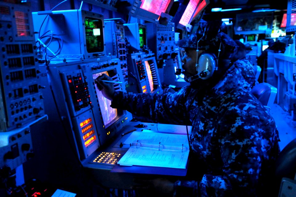 US Navy 120214-N-IO627-038 Operations Specialist 1st Class Lionel Mahoney records enemy locations during a fleet synthetic training scenario