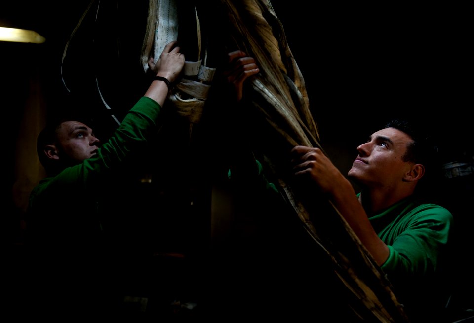 US Navy 120210-N-DR144-630 Sailors stow barricades below decks after flight deck drills aboard the Nimitz-class aircraft carrier USS Carl Vinson (C