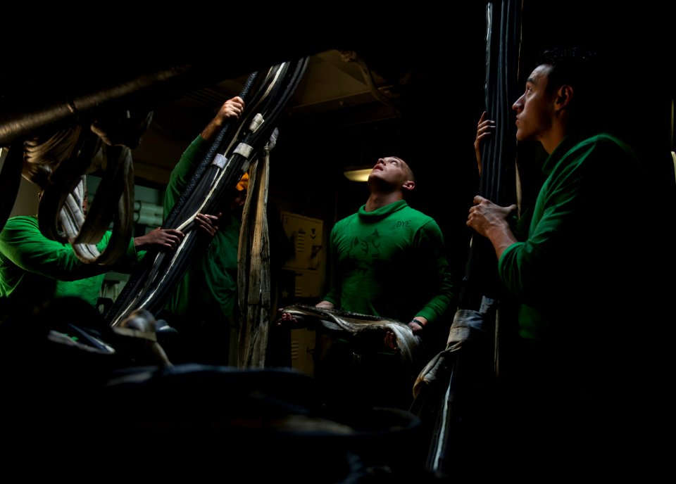 US Navy 120210-N-DR144-825 Sailors stow barricades below decks after flight deck drills aboard the Nimitz-class aircraft carrier USS Carl Vinson (C