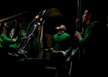 US Navy 120210-N-DR144-825 Sailors stow barricades below decks after flight deck drills aboard the Nimitz-class aircraft carrier USS Carl Vinson (C