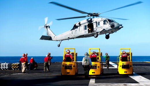 US Navy 120212-N-OY799-450 Aviation Ordnancemen observe an MH-60S Sea Hawk helicopter from the Eightballers of Helicopter Sea Combat Squadron (HSC)