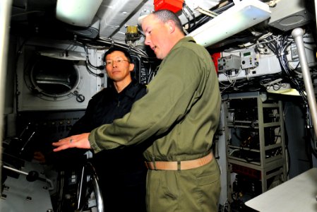US Navy 120212-N-KB563-083 Chief Operations Specialist Barnett gives Rear Adm. Kitagawa Fumiyuki a tour of Landing Craft Utility (LCU) 1632