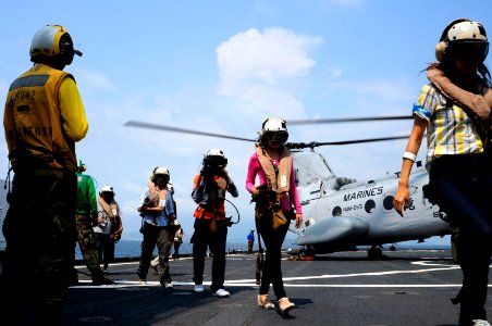 US Navy 120212-N-WV964-170 Mock non-combatant evacuation operation (NEO) participants exit a CH-46 Sea Knight helicopter aboard the forward-deploye photo