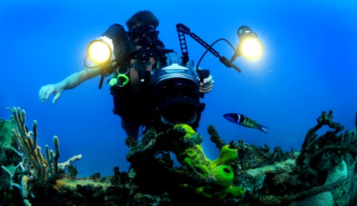US Navy 120210-N-XD935-135 Mass Communication Specialist 1st Class Shane Tuck films coral growth on the hull of a sunken naval landing craft off th