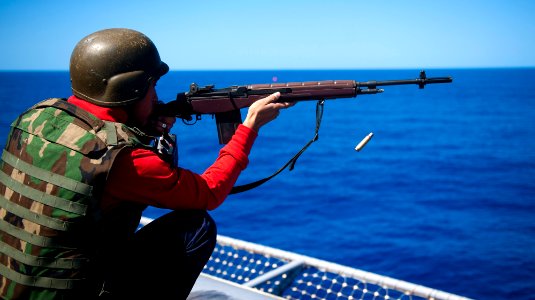US Navy 120212-N-OY799-776 Aviation Ordnanceman Airman Justin Fortuno fires an M-14 rifle during a live-fire exercise aboard the Nimitz-class aircr
